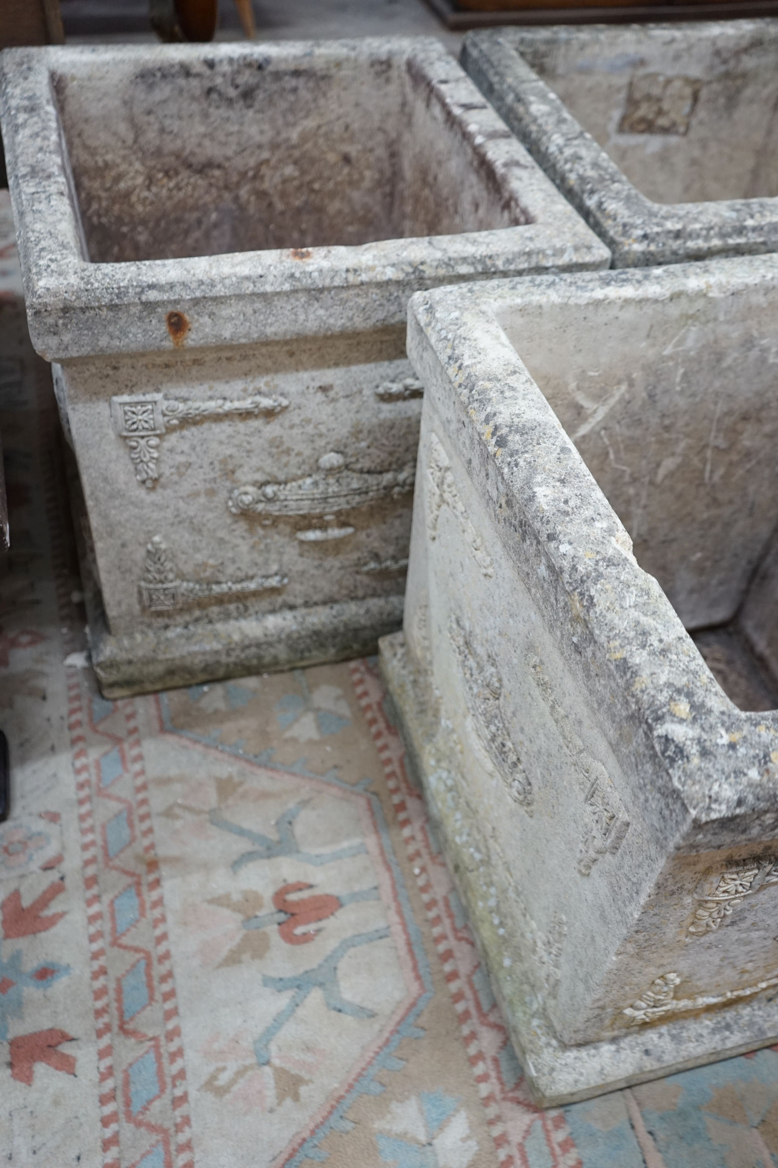 A set of three square reconstituted stone garden planters, width 47cm, height 50cm